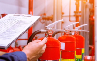 A man doing fire extinguisher inspection.
