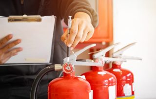 An engineer doing fire extinguisher inspection in a New Zealand Property.